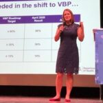 Woman speaking at a Value-Based Care event